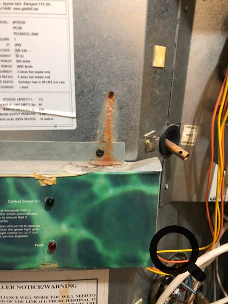 Leaking Pulsacoil 2000 showing rust penetrating through unused cable clip hole